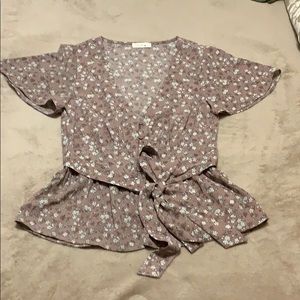 Purple fitted pleated shirt with tied around.